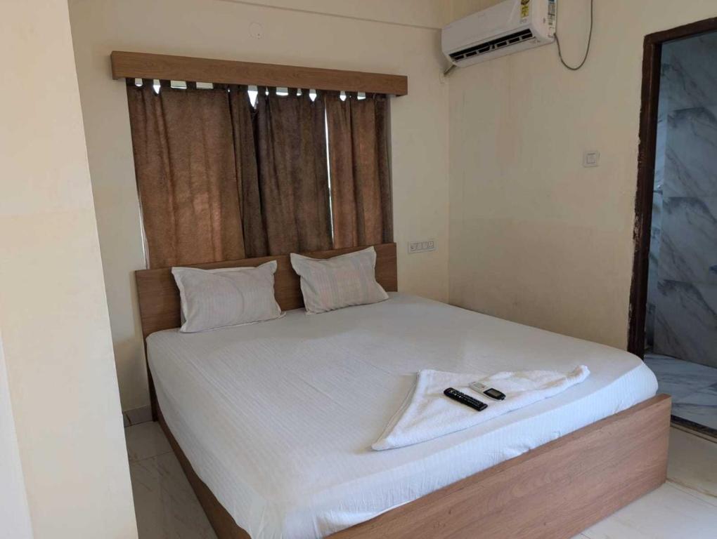 Ένα ή περισσότερα κρεβάτια σε δωμάτιο στο Collection O Dattapukur Railway Terminal Kolkata