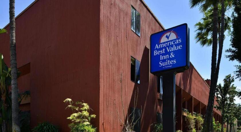 a blue sign in front of a red building at Americas Best Value Inn & Suites Los Angeles Downtown SW in Los Angeles