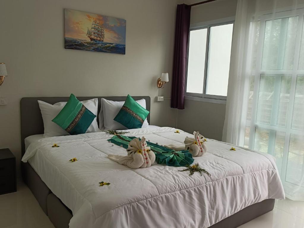 a large bed with two teddy bears on it at Mumzai House 2 in Ko Muk