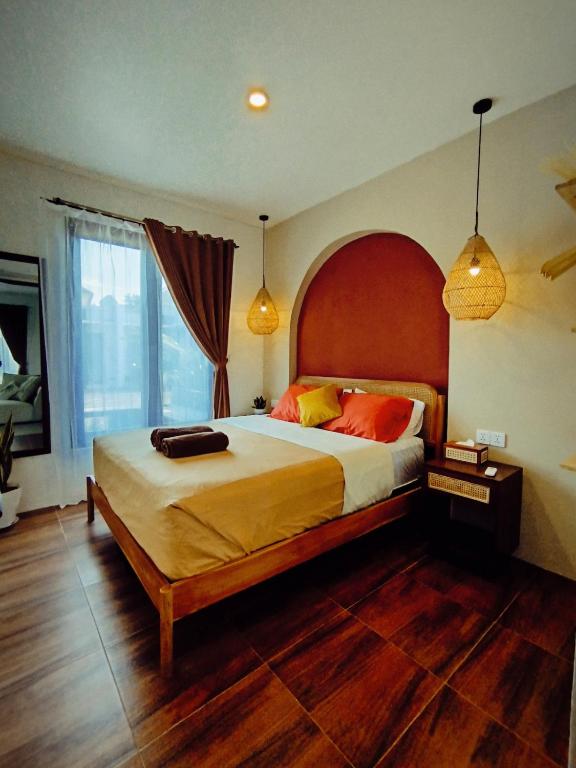 a bedroom with a large bed with a wooden headboard at Villa Omah H 25 in Ungasan