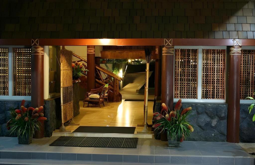 an entrance to a building with potted plants at Le Manumea Hotel in Tiavi
