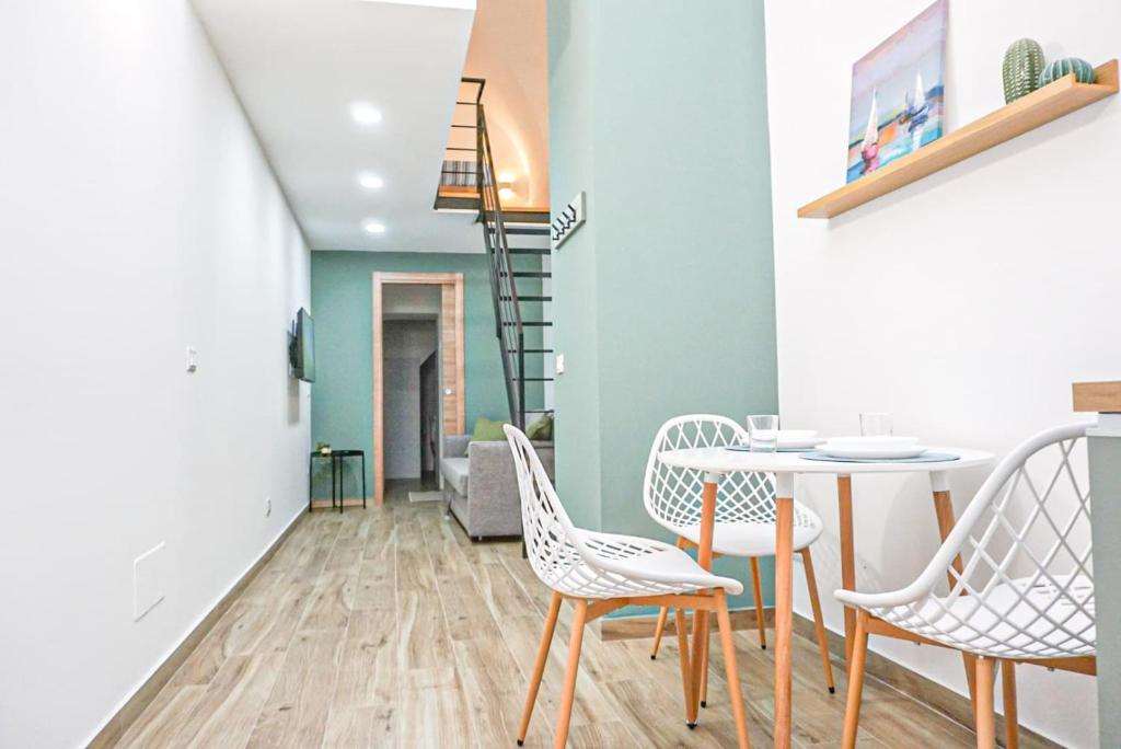 a dining room with a table and chairs at Carmelitani Loft Catania Center in Catania