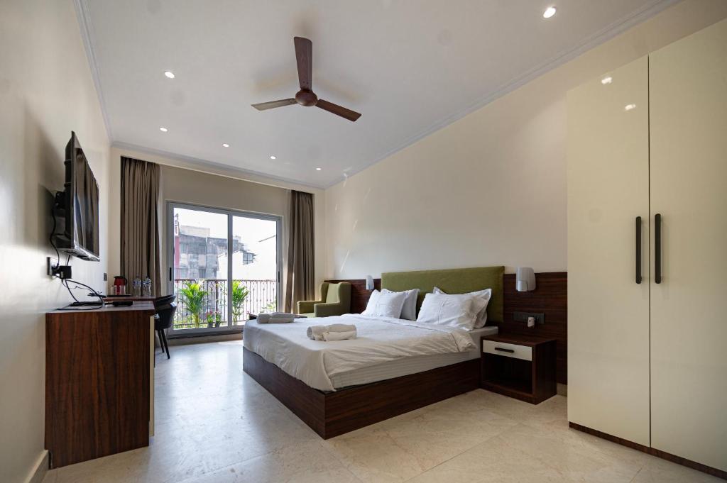 a bedroom with a bed and a ceiling fan at swastik stays in Prayagraj