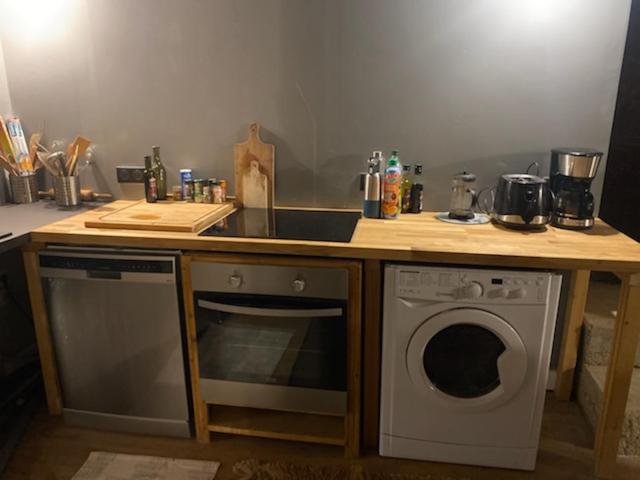 a kitchen with a counter with a sink and a dishwasher at Chalet coeur d'alpage La Plagne Les Arcs in La Plagne Tarentaise