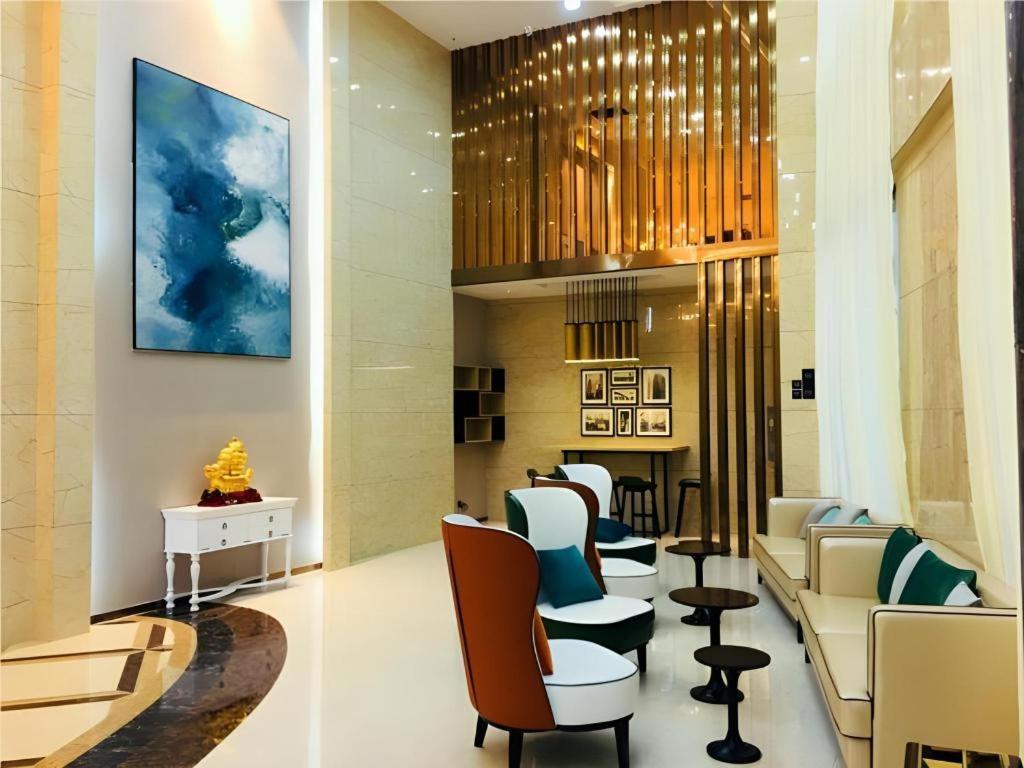 a waiting room with chairs and a barber shop at City Comfort Inn Ji'an South Administrative Center in Ji'an