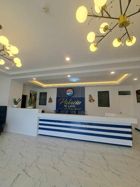 a lobby with a blue and white reception counter at Palazio De Laiya Resort Hotel in San Juan
