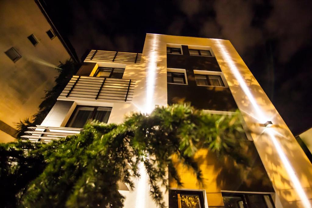 a tall building with trees in front of it at Cluj Business Class in Cluj-Napoca