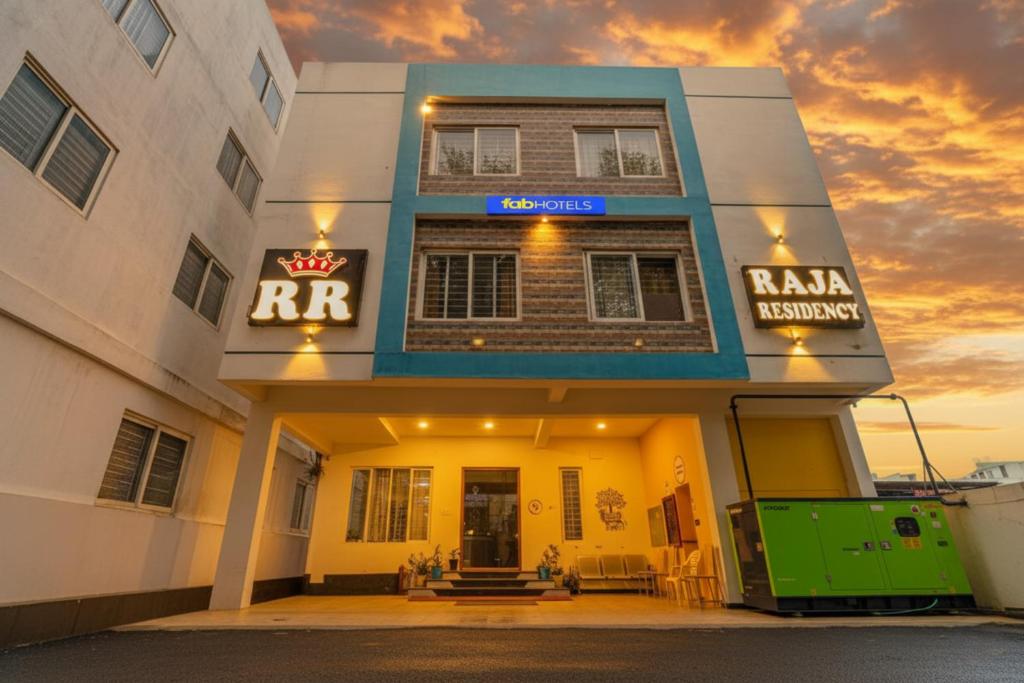a building with a raja consultancy sign on it at FabHotel Raja Residency in Alāndurai