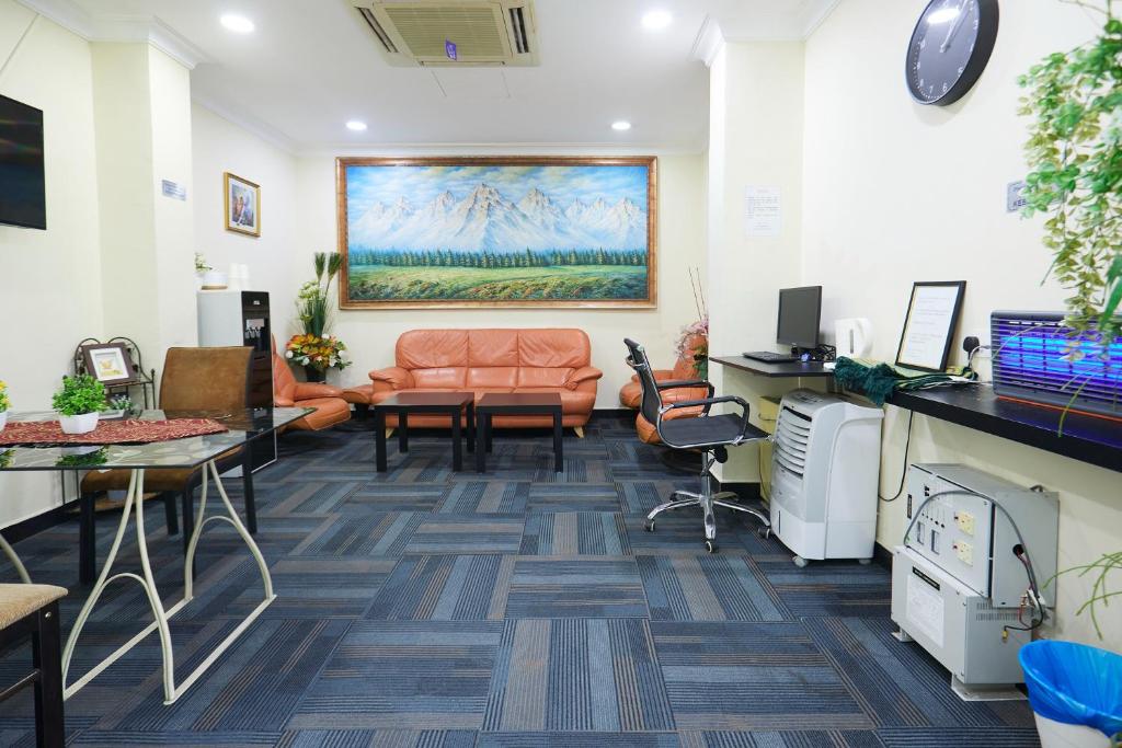 A shared lounge and work area with sofas, desks and office equipment.