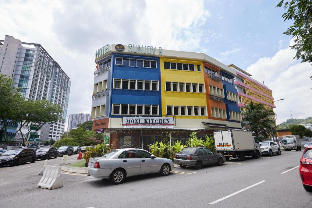 Un coche aparcado en un estacionamiento frente a un edificio. en Hotel Sunjoy9 OKR, en Kuala Lumpur