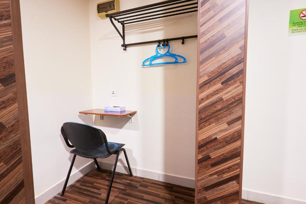A very compact work corner with a small wall-mounted desk and chair.