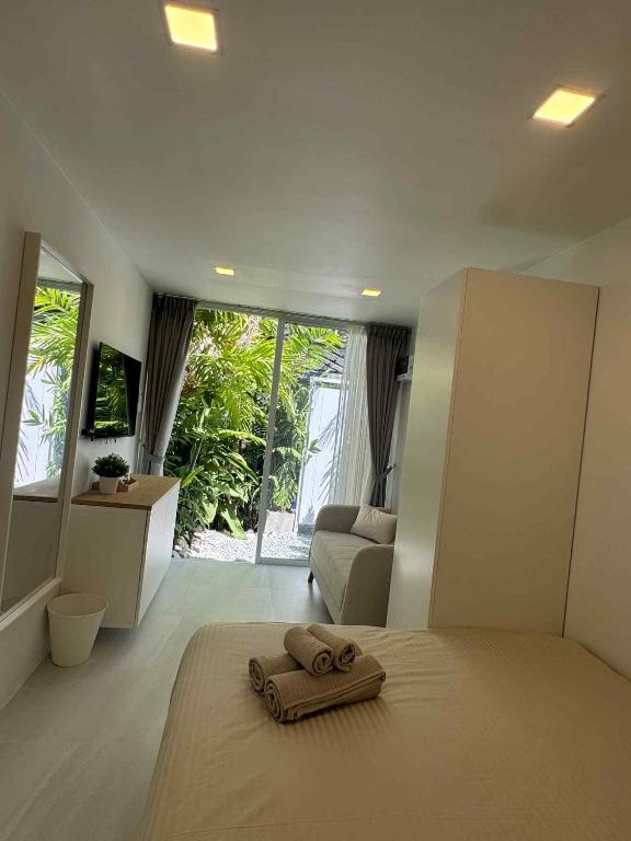 a bedroom with a bed with towels on the floor at SIAM LOUNGE - Pratumnak in Pattaya South