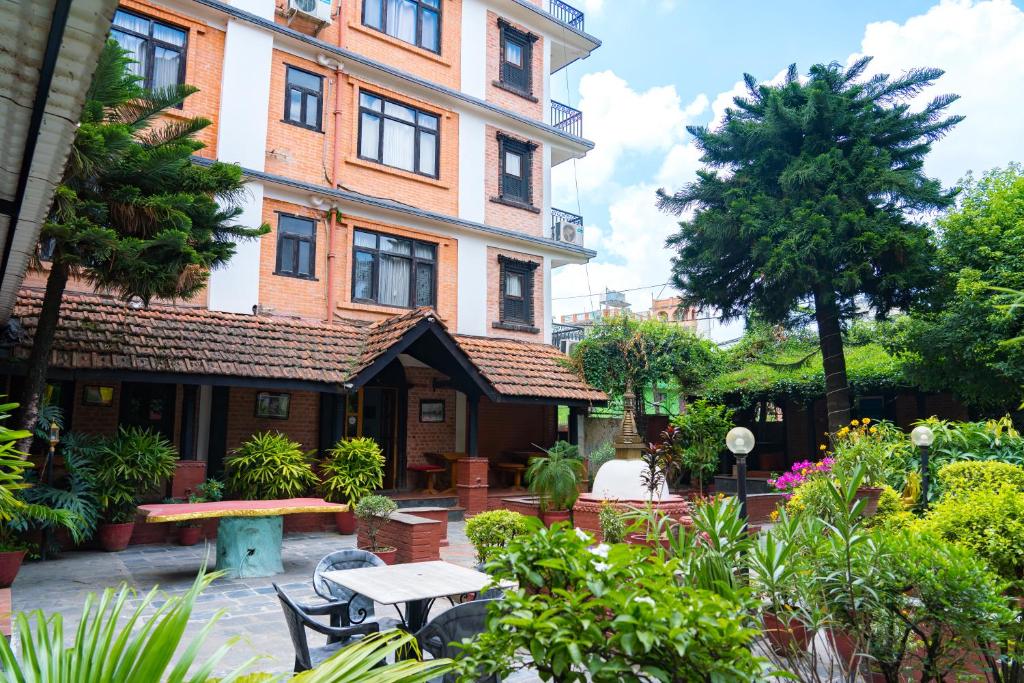 a building with a table in front of it at Hotel Ganesh Himal in Kathmandu
