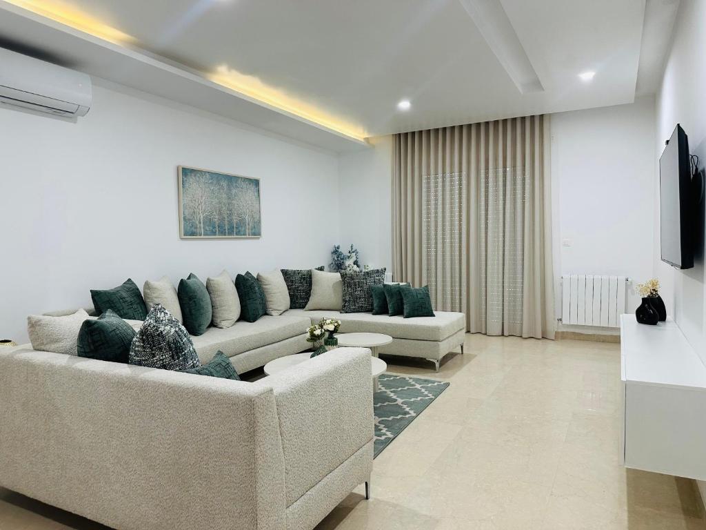 Una sala de estar con dos sofás y un televisor. en Safa, en Túnez