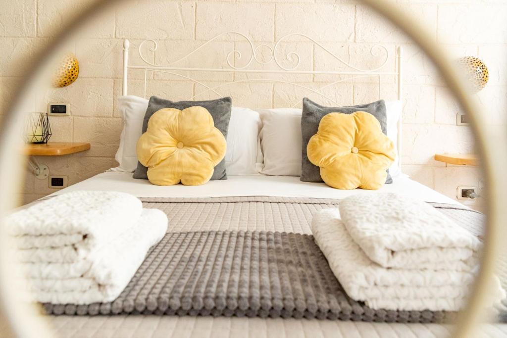 a bedroom with a bed with two pillows and towels at L'Accademia dei Sogni in Sassari