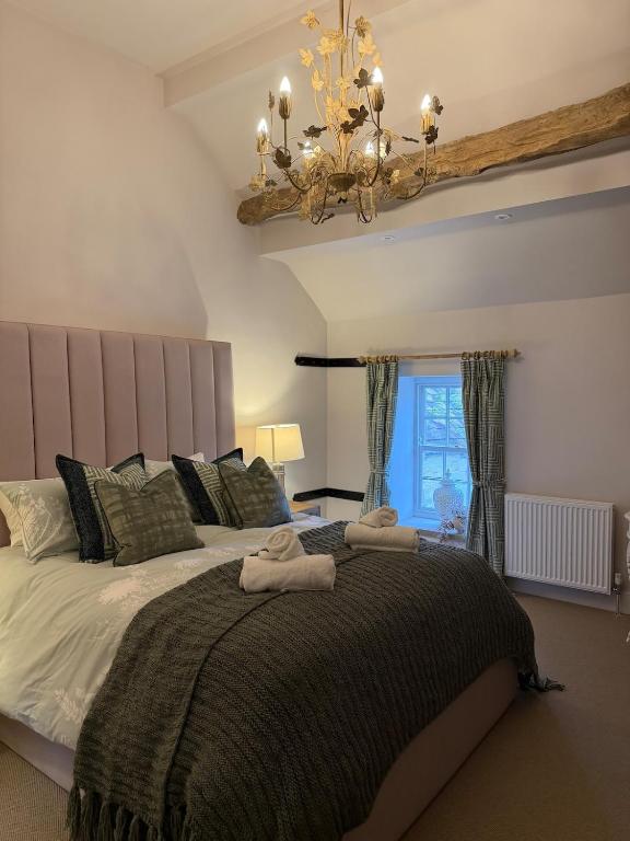 a bedroom with a large bed with towels on it at The Hayloft our perfect countryside retreat in Stoney Middleton