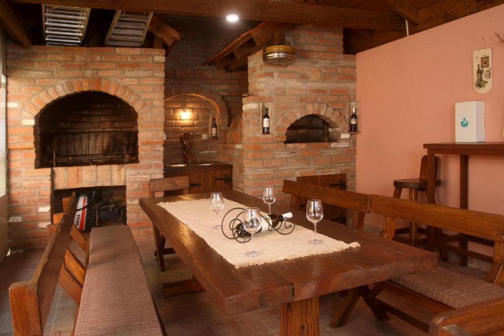 ein Esszimmer mit einem Tisch und einem Steinofen in der Unterkunft Villa Vesna in Opatovac