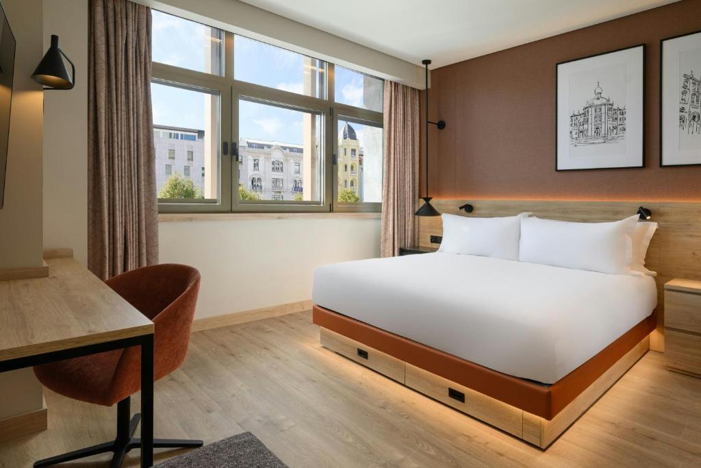 a hotel room with a bed and a desk at Residence Inn Lisbon by Marriott Hotel in Lisbon