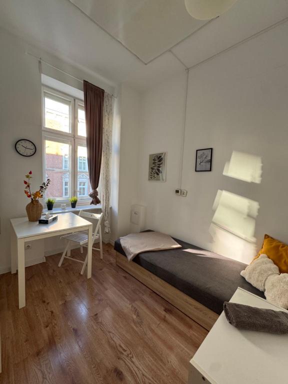 Ένα ή περισσότερα κρεβάτια σε δωμάτιο στο Pokoje przy Rynku I