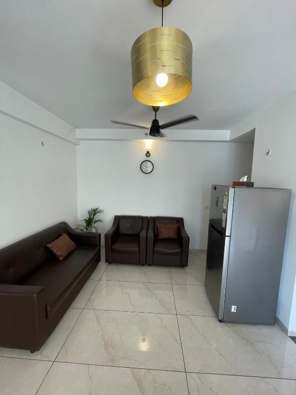 a living room with a couch and a ceiling fan at Vaibhav Stays in Nalmatha