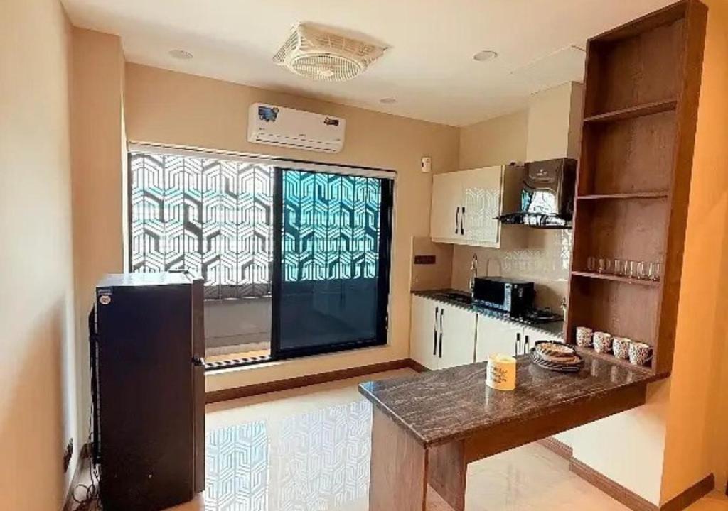 a kitchen with a large window and a table in it at City View Residence in Islamabad