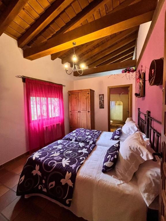 a bedroom with a large bed in a room at Casa Rural El Regajo in Tenzuela