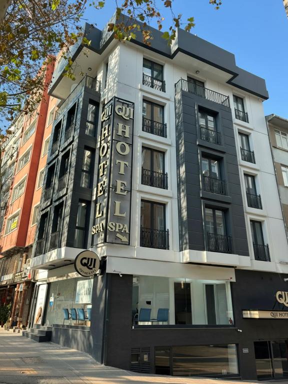 a building with a sign on the side of it at QUİ Hotel&SPA in Istanbul