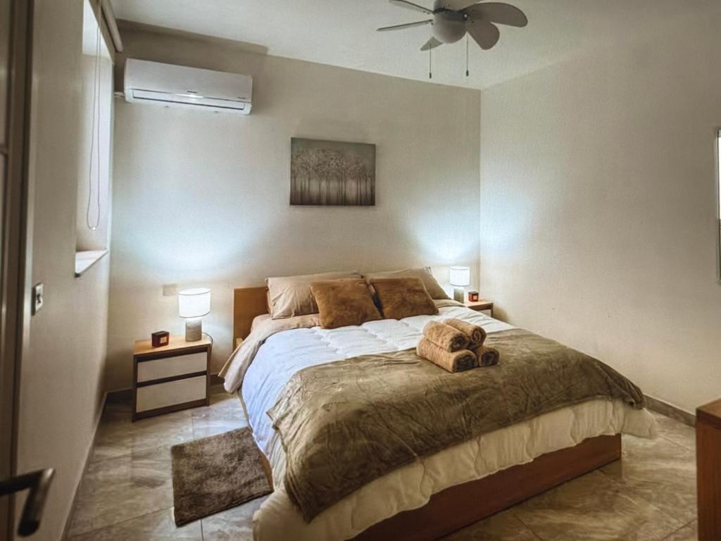 a bedroom with a large bed with two stuffed animals on it at Modern malta in Marsaskala