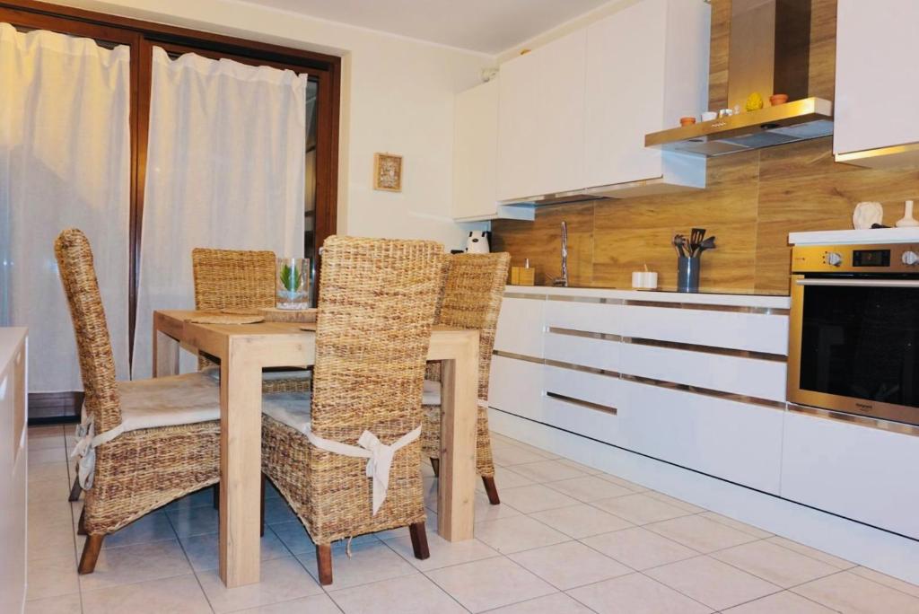 een keuken met een houten tafel en stoelen bij Dimora Bohém in Cantù