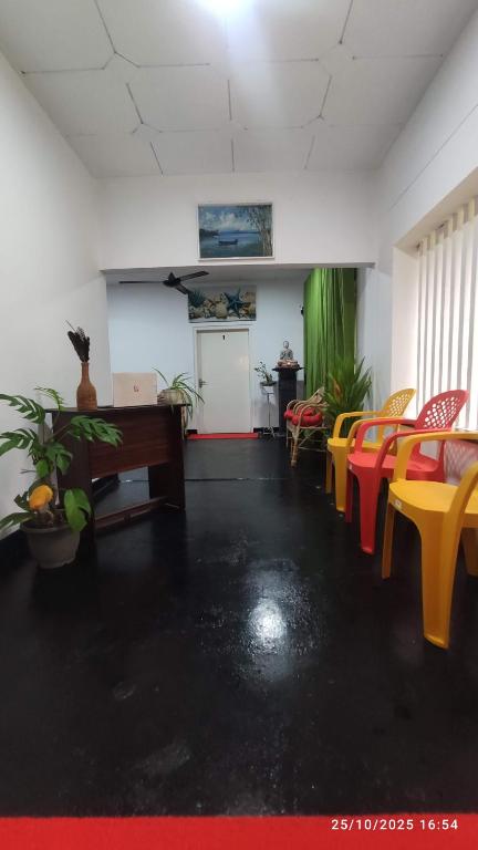 a room with chairs and a table and a desk at EVOKE Hostel Mirissa in Mirissa