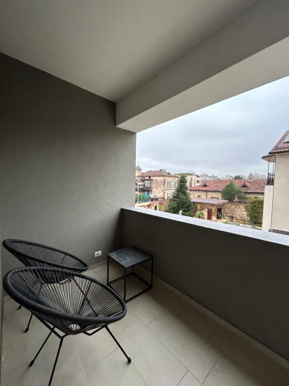 a balcony with a chair and a window at C&E Apart in Craiova