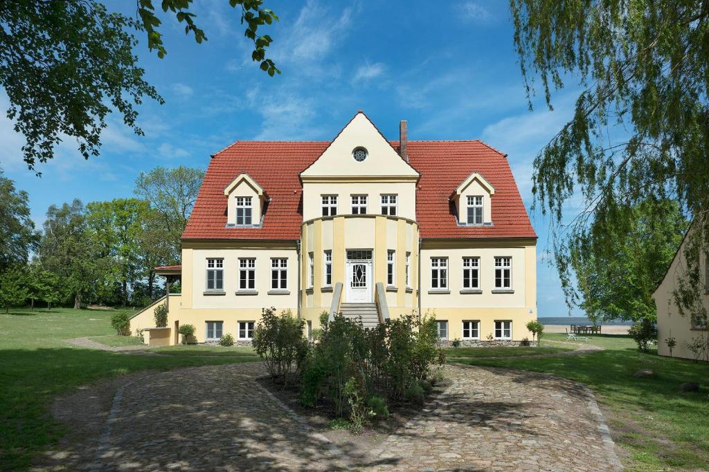 a large house with a red roof at Wohnung Im Zweiten Obergeschoss Des Gutshauses in Neuenkirchen