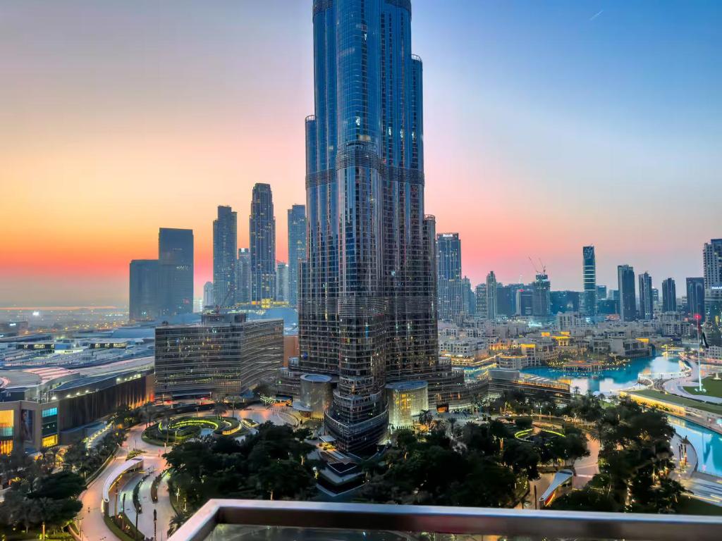 a view of a city with a tall skyscraper at Luxurious 3 BR with Burj Khalifa View in Downtown in Dubai