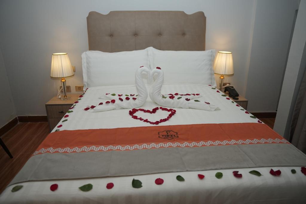 a bed with a heart decoration on top of it at Yofel Hotel in Dirē Kʼalu