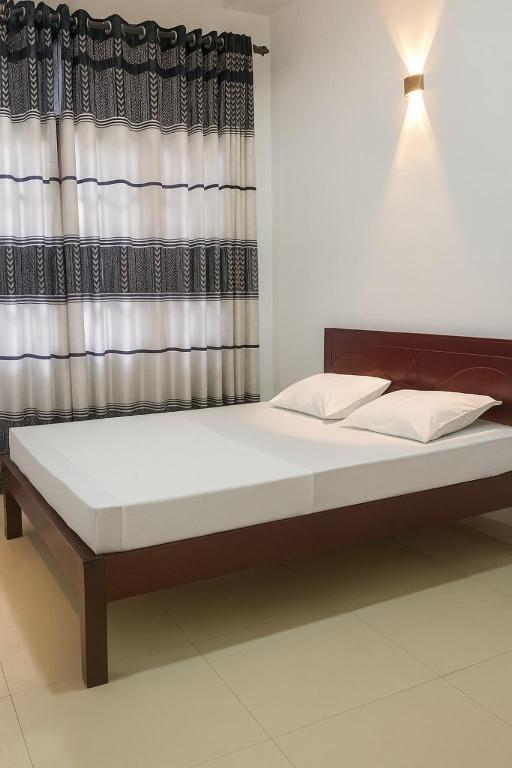 a large bed in a room with a window at Comfy Stay in Badulla