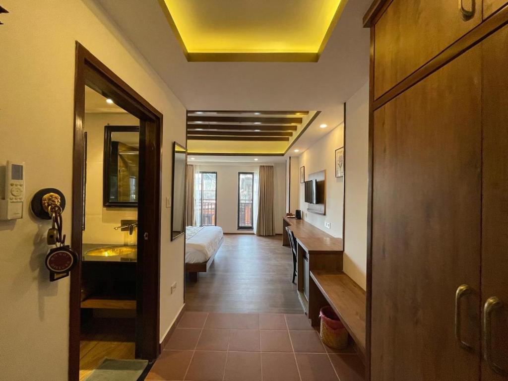 a hotel room with a bed and a bathroom at Ambassador Garden Home in Kathmandu