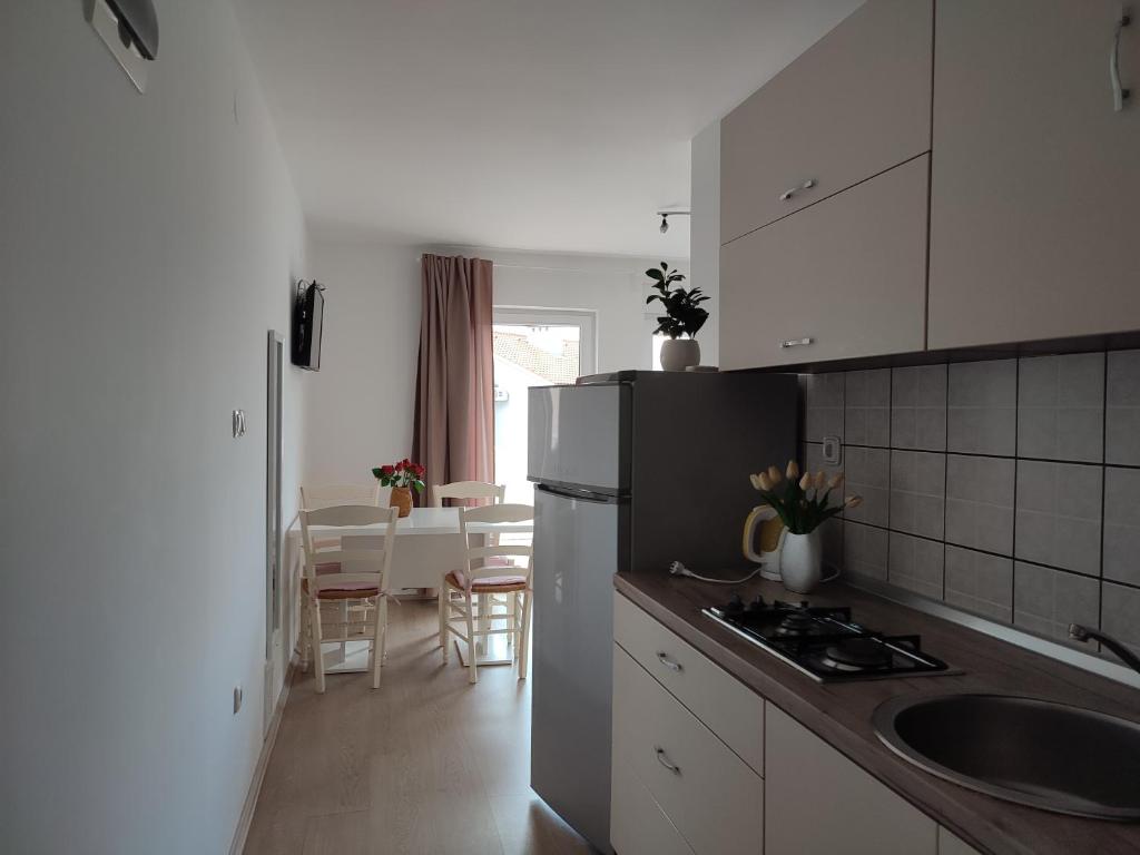 a kitchen with a sink and a refrigerator in it at Villa Ivka - 100 m do plaže uvala Soline - KRK in Malinska