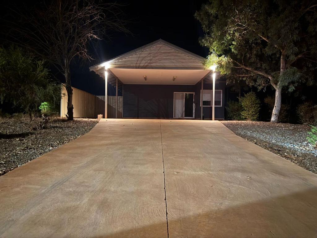 Ein Haus mit zwei Lichtern auf der Einfahrt bei Nacht in der Unterkunft Newman Short Term Accommodation Rooms in Newman