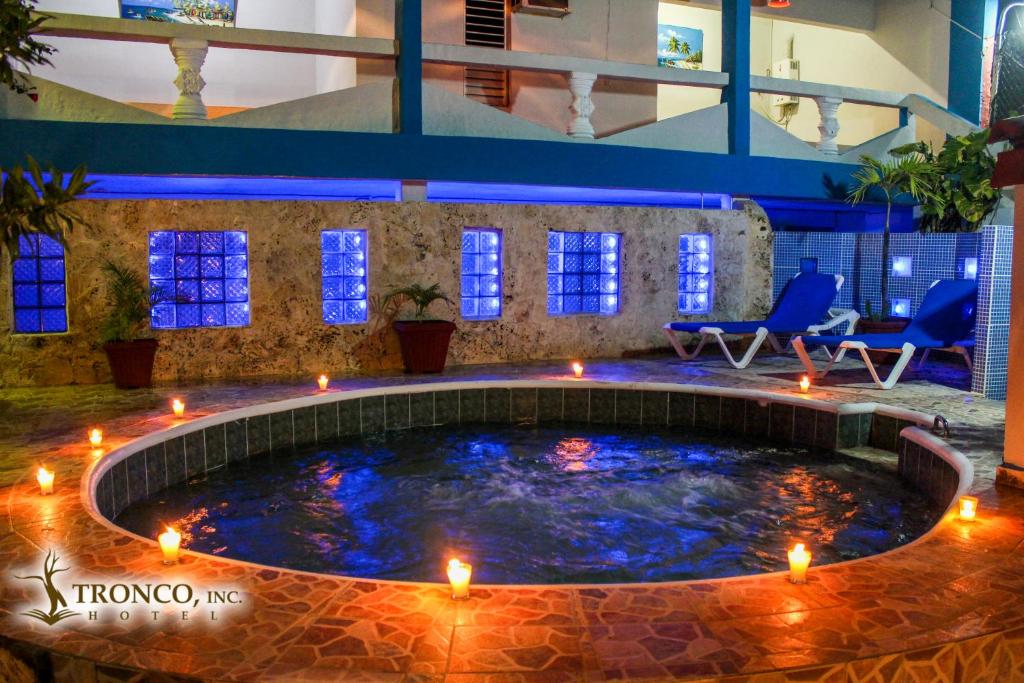 a large pool with lights in a building at Hotel El Tronco Inc in Boca Chica