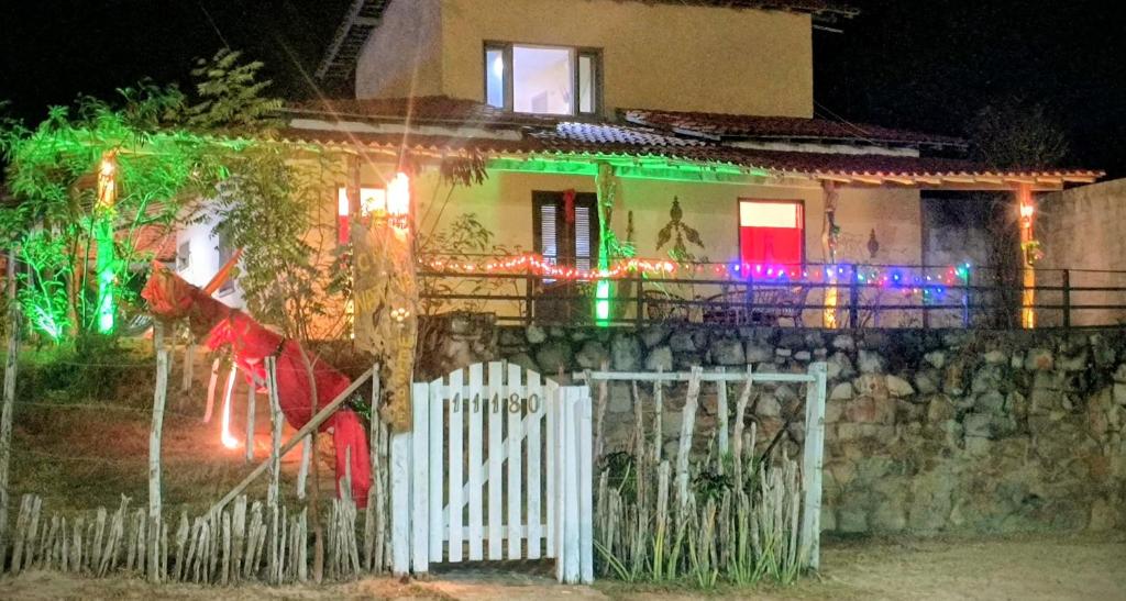 a house with christmas lights on the front of it at Casa Nativa Coqueiro II in Luis Correia