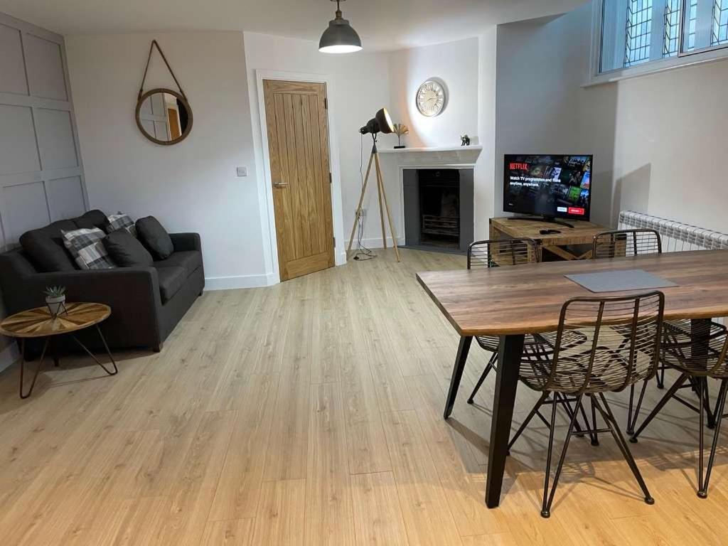a living room with a couch and a table at The Old Town Hall - Flat 4 in Grove
