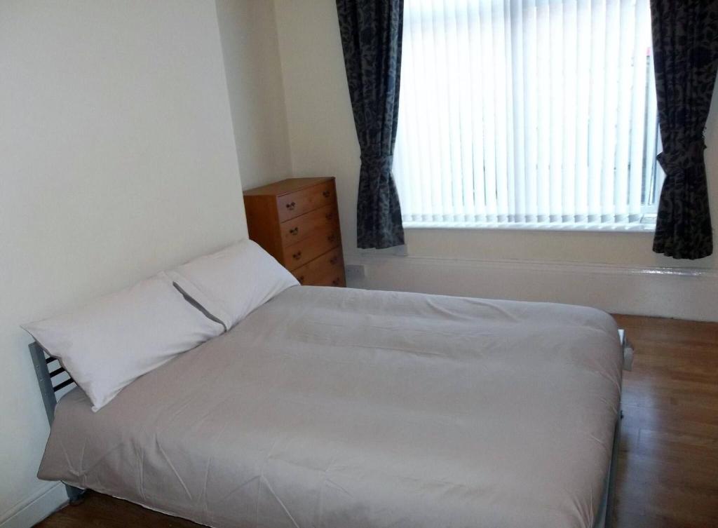a bedroom with a white bed and a window at Private Room, Sunderland City in Sunderland