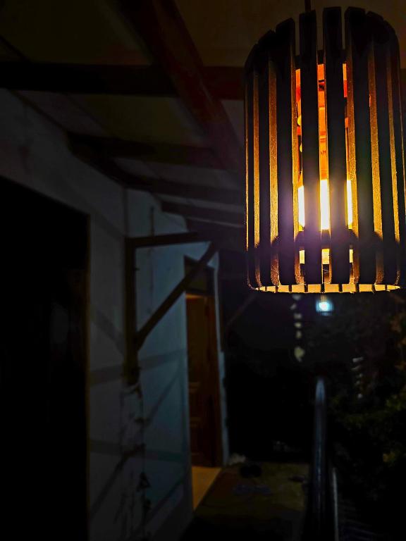 a light hanging from a ceiling in the dark at Sea Bay in Kamburugamuwa