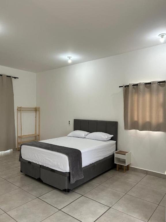 a bedroom with a large bed in a room at Flat Monte Mor Jardim Monte Verde in Monte Mor