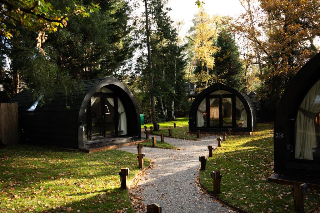 a group of domes in a park with a path at AvantGlamp in Marston Green