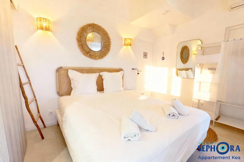 a bedroom with a white bed with towels on it at VILLA SEPHORA CANNES in Cannes