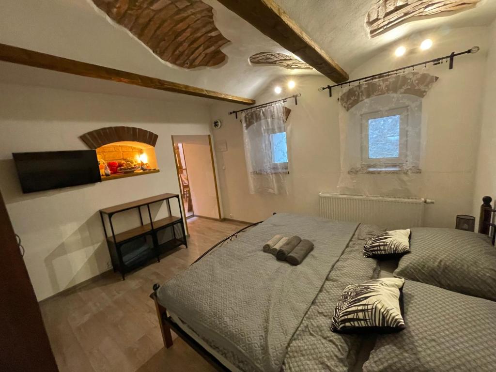 a bedroom with a large bed and a fireplace at Apartmany Pod Kloboukem in Jáchymov