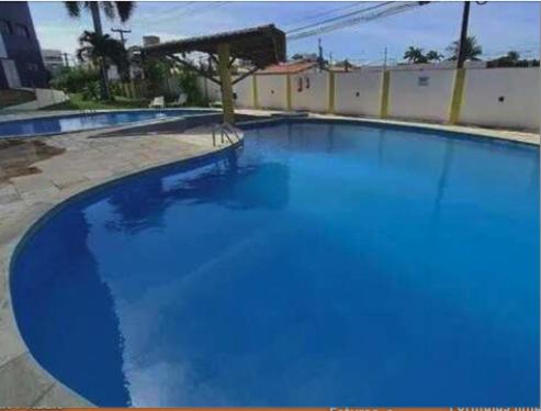 a large swimming pool with blue water in it at Polyglot Family in Natal