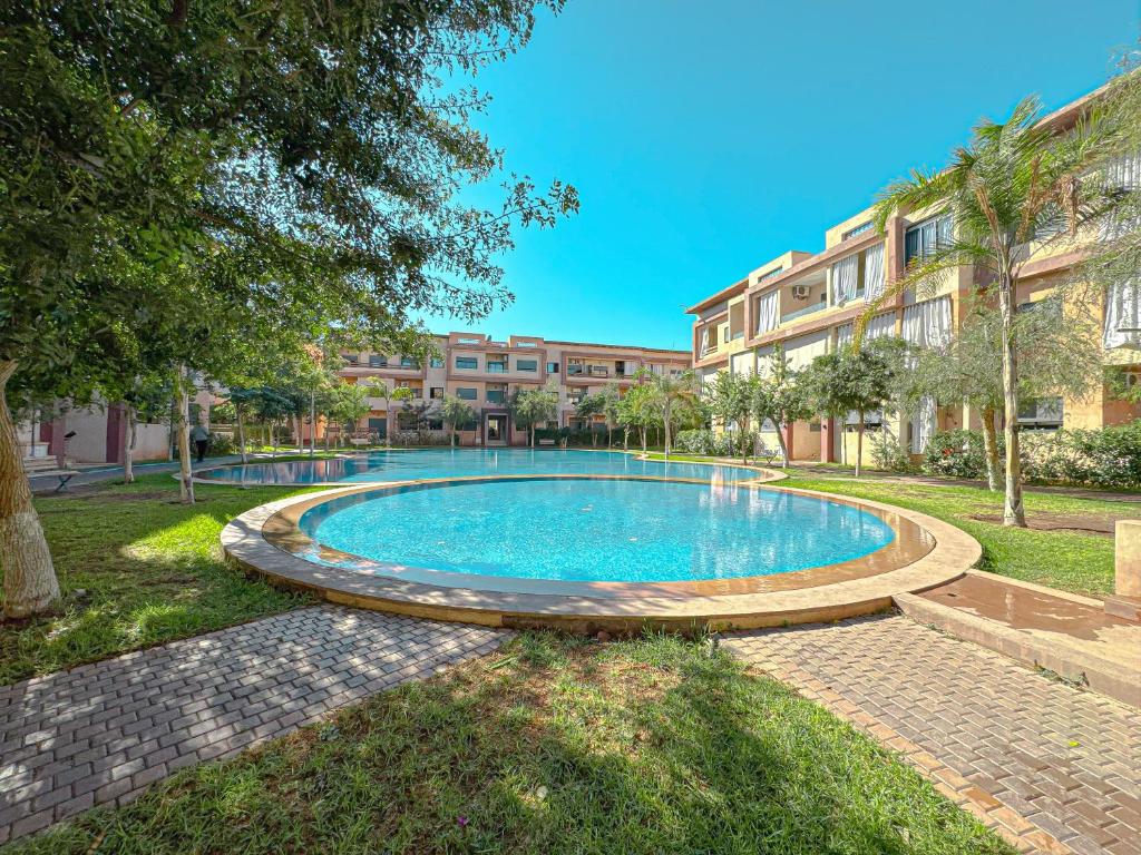 a swimming pool in the yard of a building at charming and cozy studio with swimming pool in Marrakesh