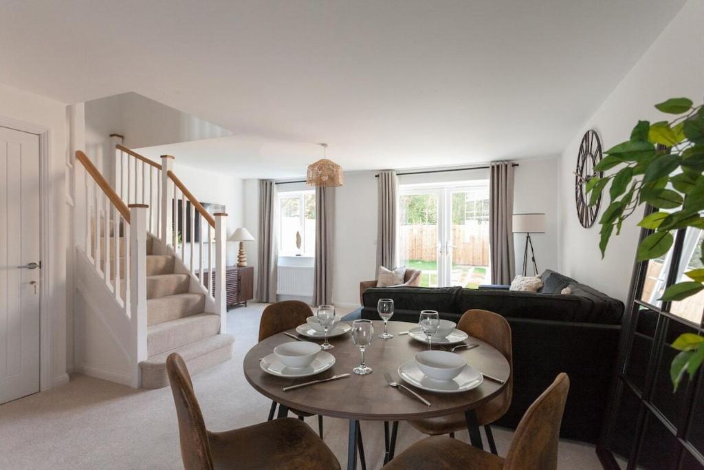 a living room with a table and chairs at Runcorn Spacious Modern 3 bedroom House, 4 beds, On site Parking, Long stay deals in Runcorn